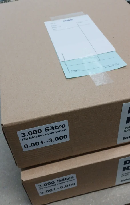 Zwei Kartons mit 60 Kellnerblocks auf einem Tisch.